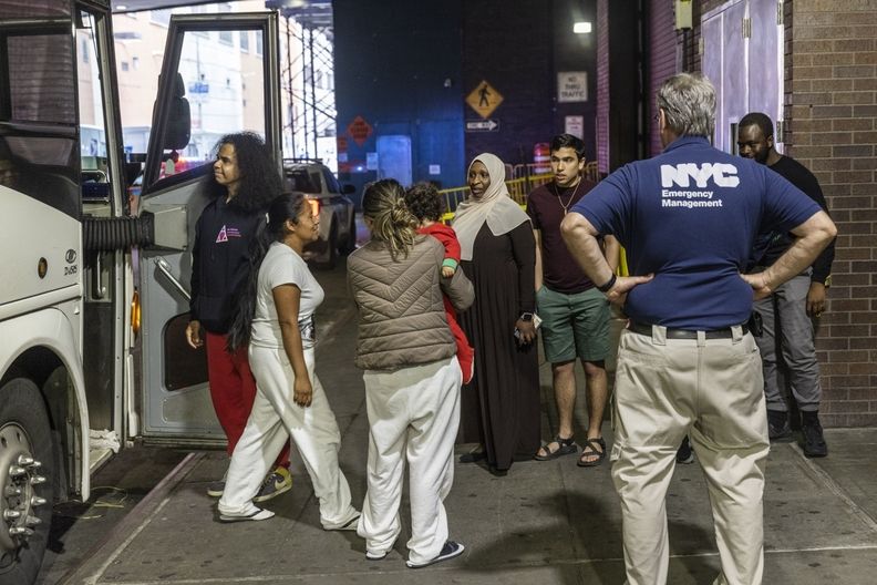 Migrants exit a bus in New York City.